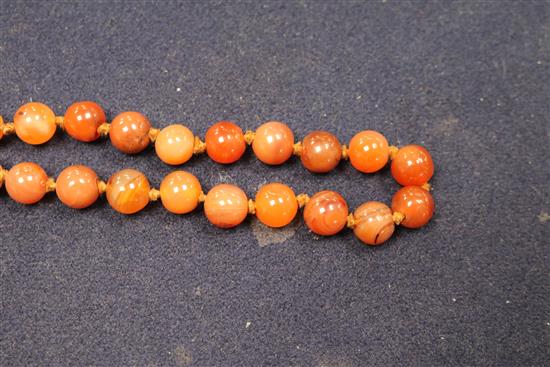 An early 20th century banded agate and other hardstone bead necklace, 80cm.